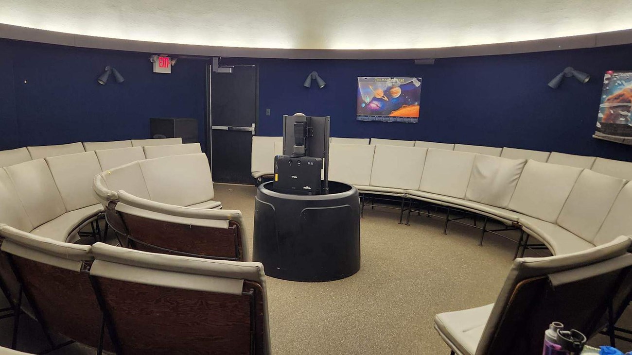 Gray benches in a ring around a projector