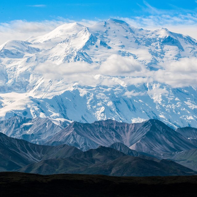 Snow-covered peak with smaller mountains in foreground