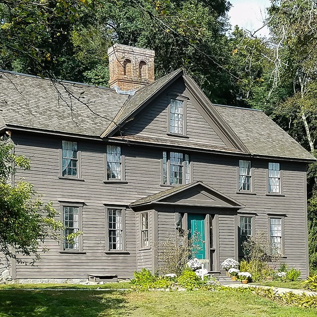 front facade of two-story wooden colonial house