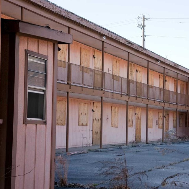 A hotel with boarded up windows