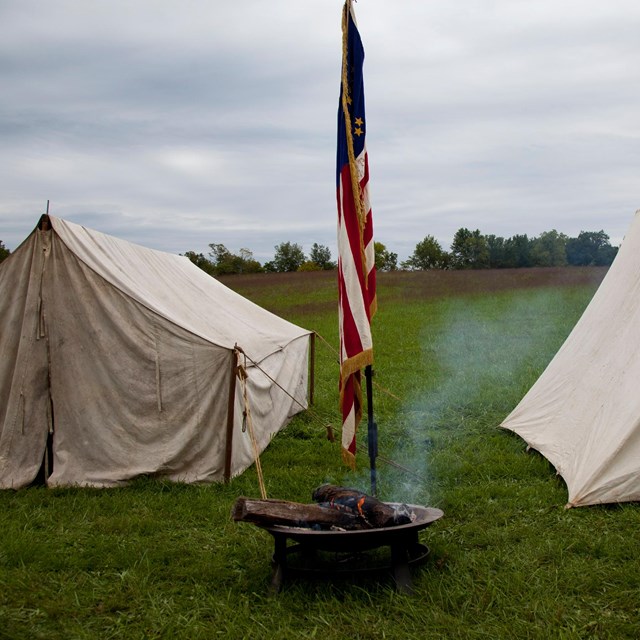 Tents set up on battlefield as part of reenactment. 