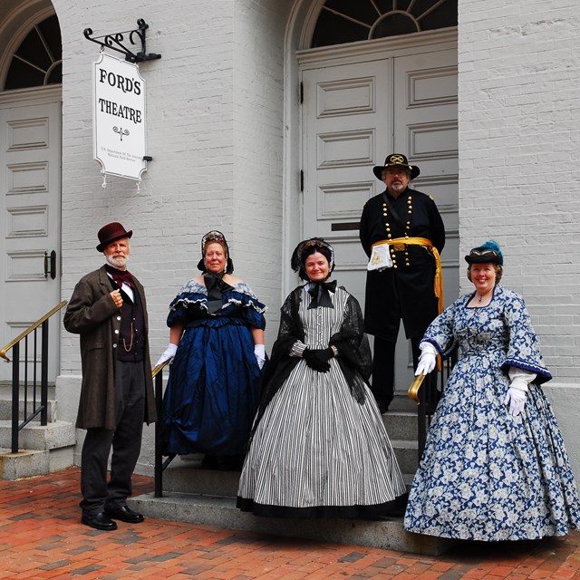 Actors and actresses stand in front of Ford\'s Theatre.