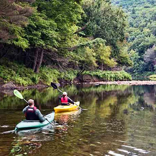 two kayakers on a calm stretch of open river on the Westfield