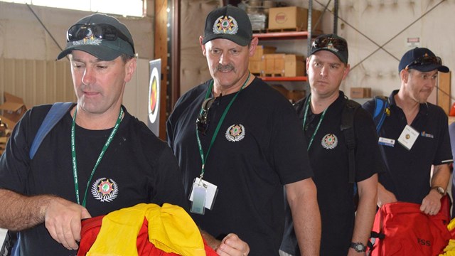 Firefighters from New Zealand check out fire gear as they prepare to support the U.S. during the 201