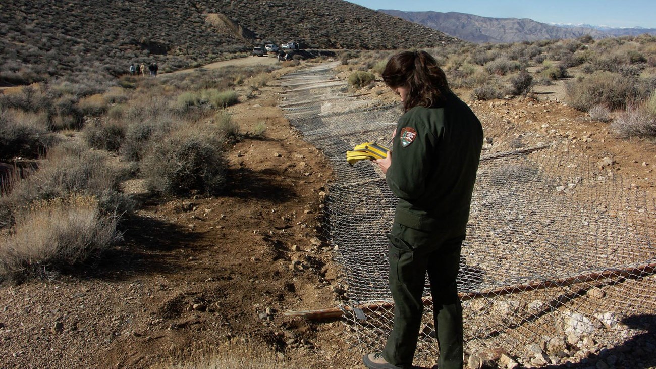 A ranger surveys a dangerous mine opening