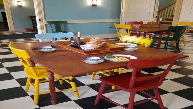 Colorful chairs at tables in the dining room of the Lemon House.