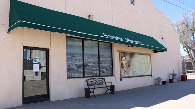 Building with a green awning that reads "Amache Museum."