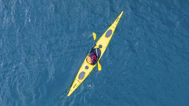 Aerial photograph of kayaker on water.