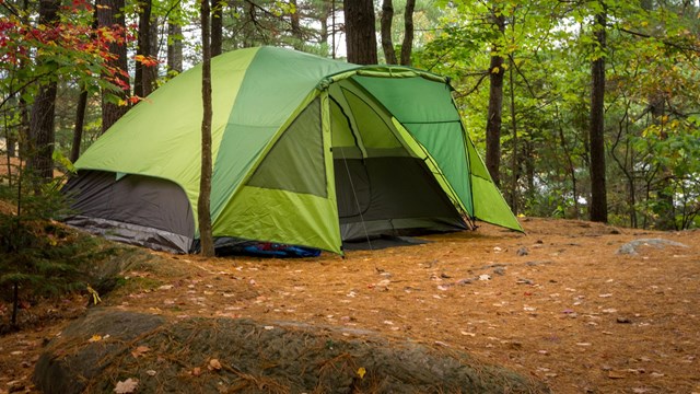 Photograph of tent in woods.