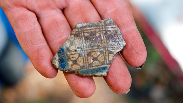 Ceramic sherd on hand.