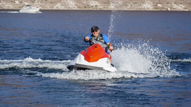 A person smiles while on a vessel.