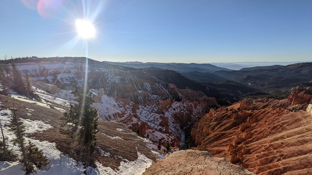 Red ground partially covered with snow