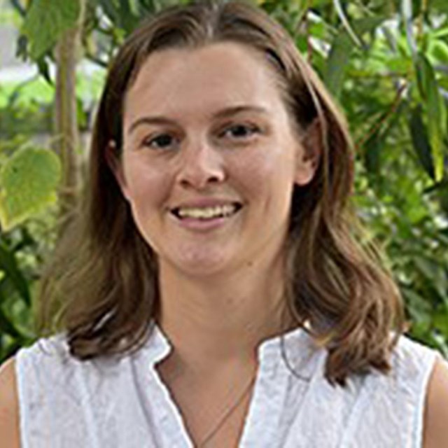 Portrait of Veronica with trees in the background.