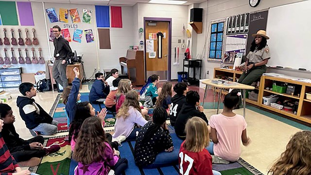 A ranger talks to a group of twenty students about Civil Rights.
