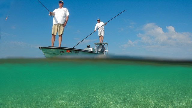 Two people fishing on a boat