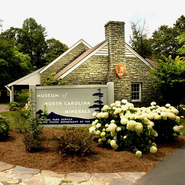 Museum of North Carolina Minerals building with parkway sign and entrance path.