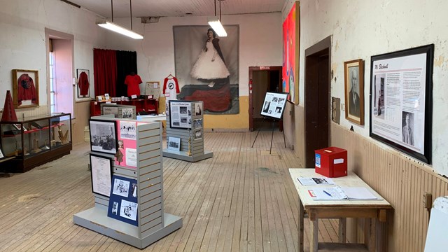 Image depicting interior exhibits and information with original wood features. 