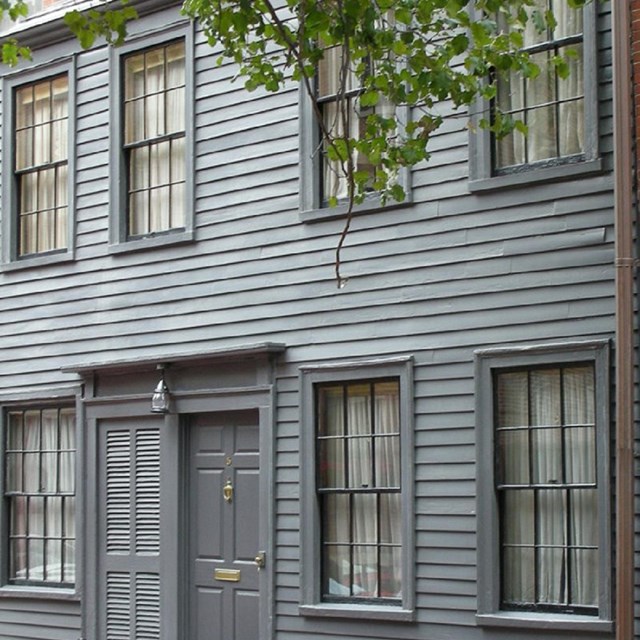 gray residential home with gray wood side panels.