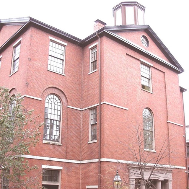 three story red brick building 