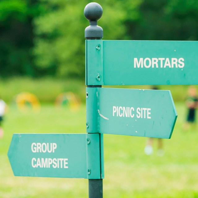 Signpost on Peddocks Island pointing to a campsite, picnic site, and mortars