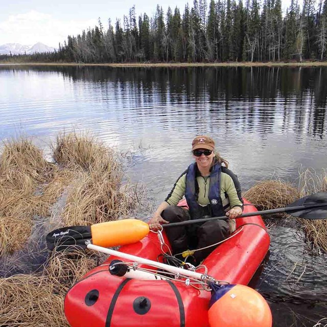 A researcher monitoring a shallow lake.