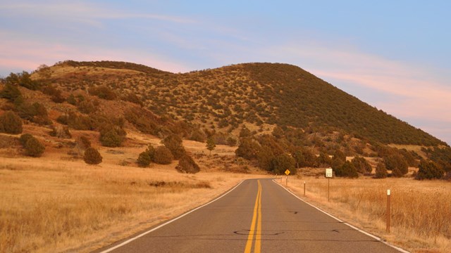 Two lane highway heading towards Capulin Volcano.