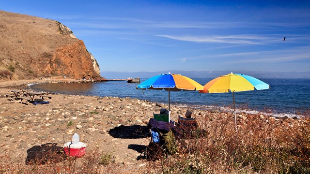 Visitor relaxing on beach with umbrellas. ©Tim Hauf, timhaufphotography.com