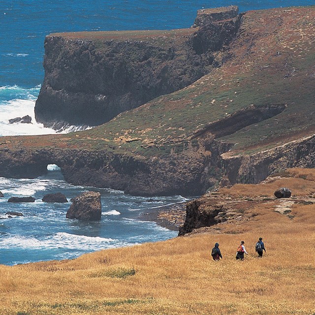 Visitor hiking along coastal bluff. ©Tim Hauf, timhaufphotography.com