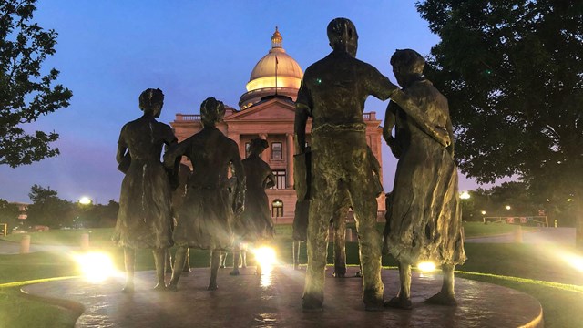 The Testament statues of the Little Rock Nine at sunset