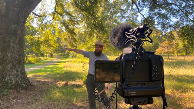 Park Ranger speaks behind camera in summer. 