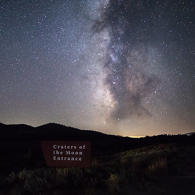 Milky Way illuminates the sky over a sign that reads 