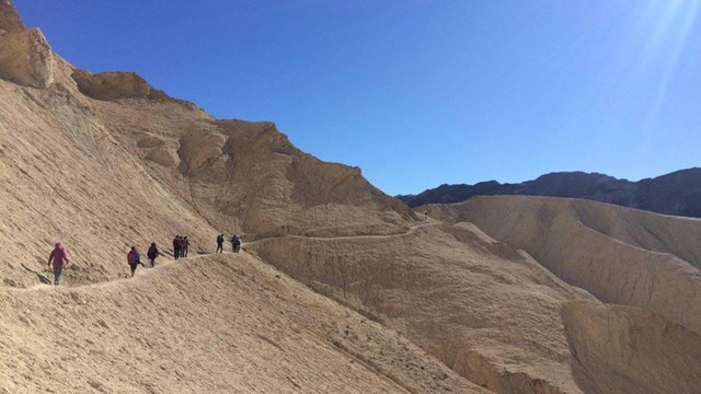 Hikers beneath Manly Beacon on the Gower Gulch Loop