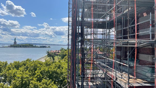 Scaffolding covers part of the building on Ellis Island.