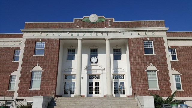 Public brick building with "Floyd Bennett Field" over the entrance