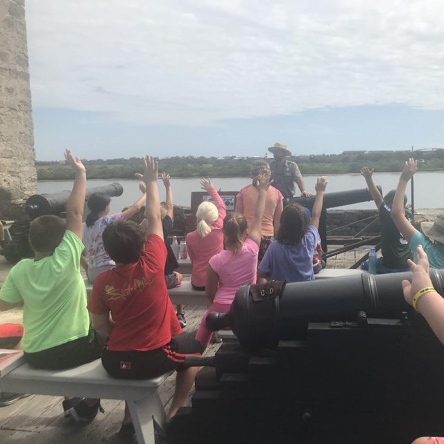 Group of students with a ranger on the gun deck. 