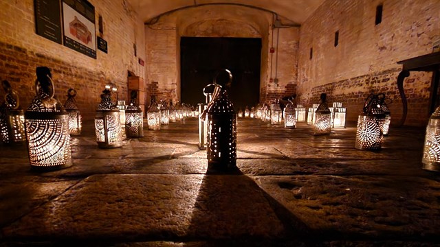 Candlelight lanterns arranged on the ground in the sally port