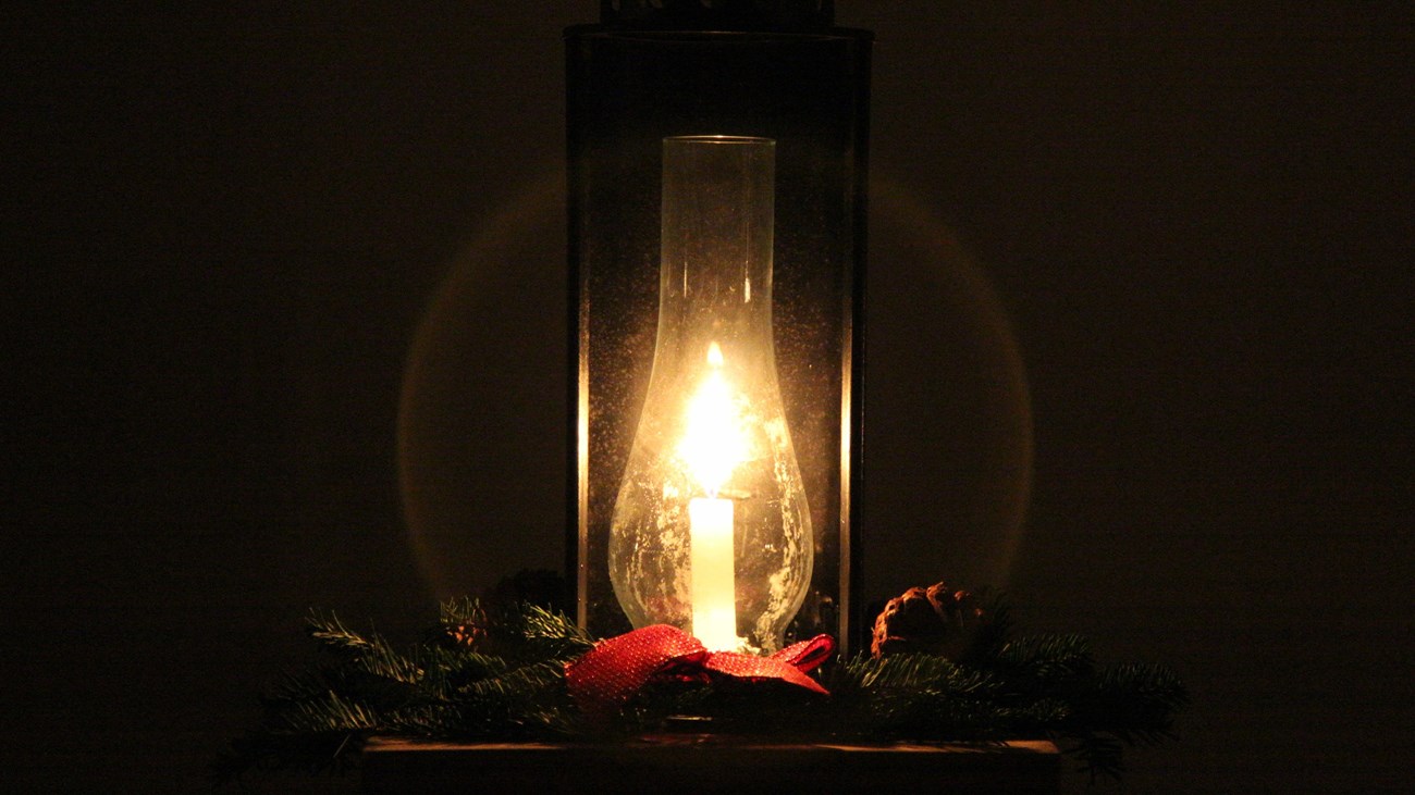 An oil lamp lit in the darkness.