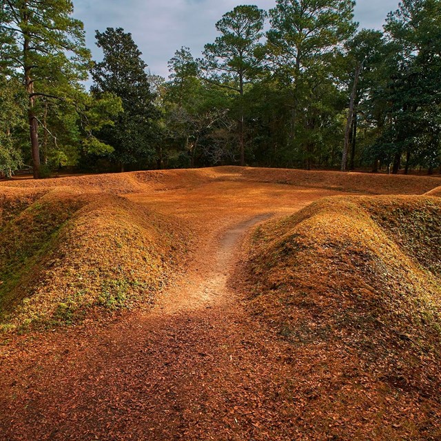 Reconstructed earthen fort covered in grass