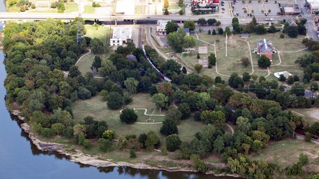 Aerial photo of Arkansas River, first fort foundation, commissary, visitor center, and gallows.