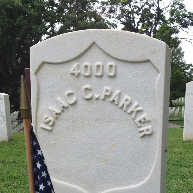 A white headstone with text reading 