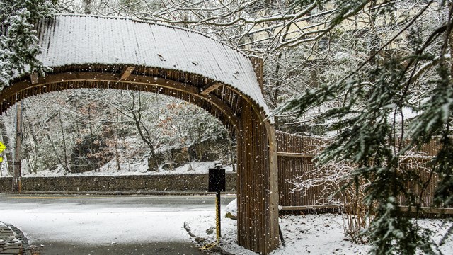 Snowflakes fall around the entry.