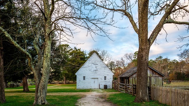 white craftshop and wooden tobacco barn