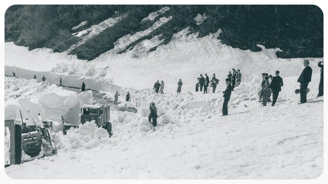 black and white image of people watching snow plowing