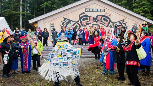 Tribal member dances in front of the Tribal House dedication