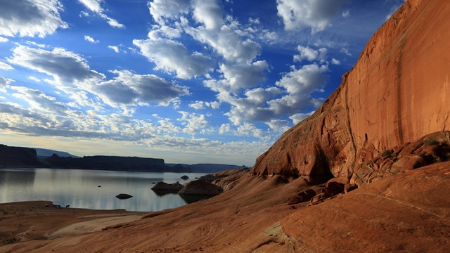 Landscape scene with sandstone wall and lake