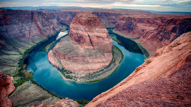 River makes a circular bend around sandstone escarpment.