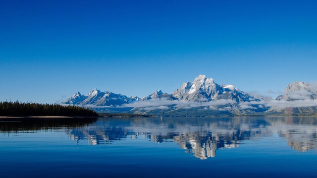 A boat dock with mountains in the distance.