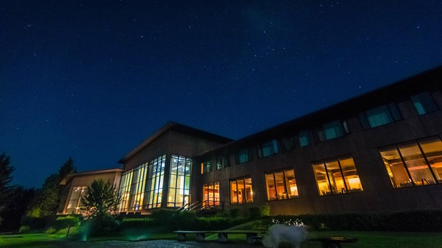 A building lit up under the stars.