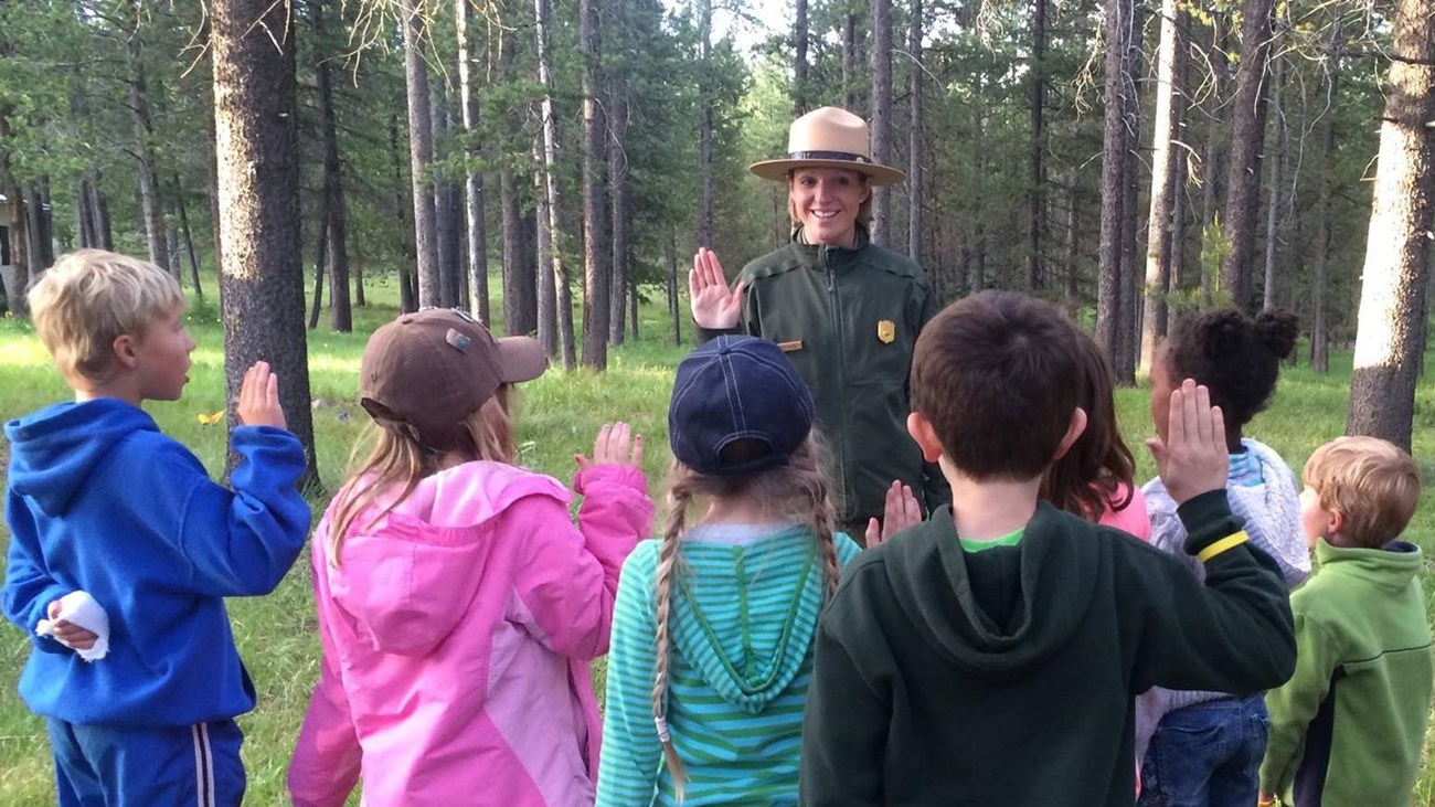 Kids getting sworn in as junior rangers by a park ranger