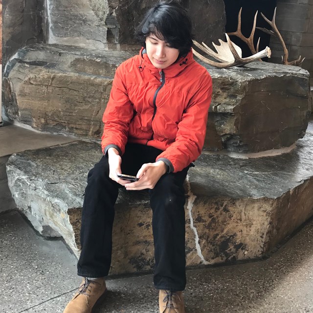 visitor texting at the craig thomas discovery and visitor center